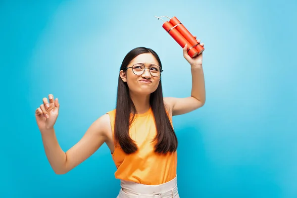 Emotional Asian Girl Glasses Holding Dynamite Sticks Head Blue — Stock Photo, Image