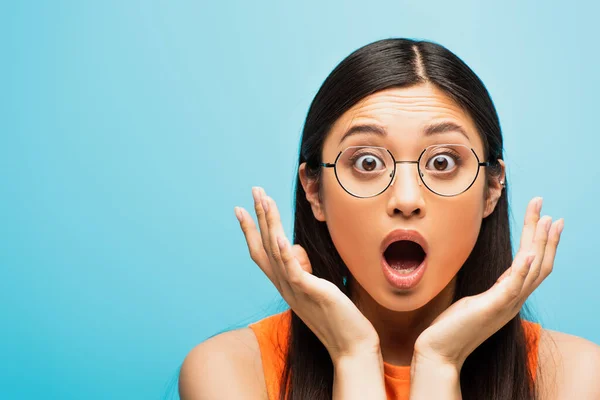 Shocked Asian Woman Glasses Gesturing Looking Camera Isolated Blue — Stock Photo, Image