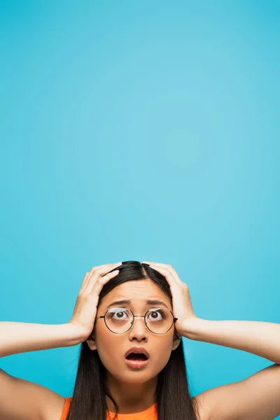 Surprised Asian Woman Glasses Touching Head Isolated Blue — Stock Photo, Image