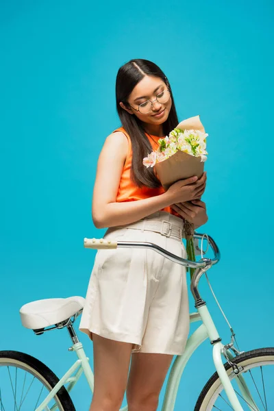 Beautiful Asian Girl Glasses Looking Flowers Bike Isolated Blue — Stock Photo, Image