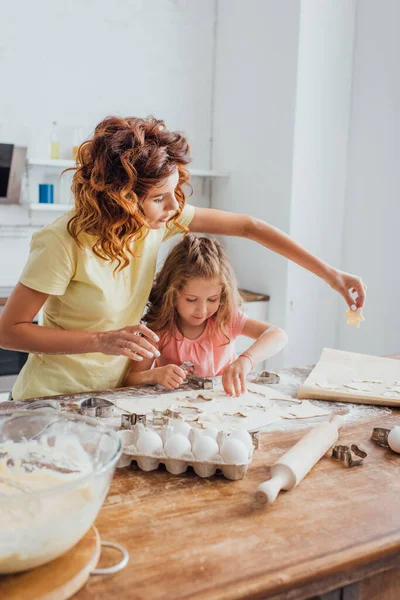 Selective Focus Mother Putting Cookie Baking Paper Daughter — Stock Photo, Image