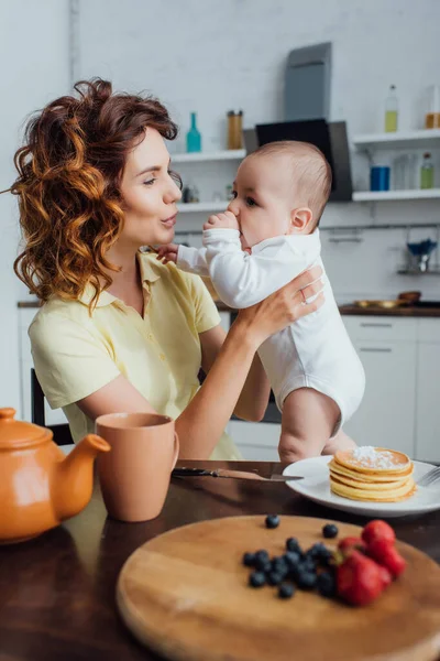 Selective Focus Young Mother Holding Infant Son Table Served Pancakes — Stock Photo, Image