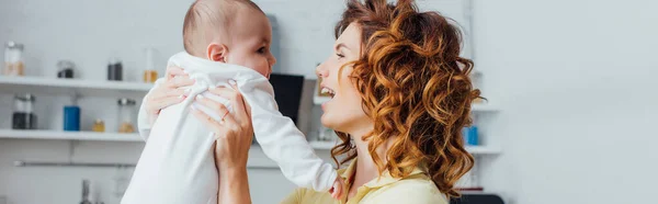 Panoramic Crop Young Curly Mother Holding Infant Boy Kitchen — Stock Photo, Image