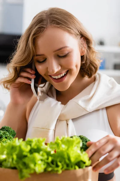 Selective Focus Young Woman Touching Fresh Lettuce Broccoli While Talking — Stock Photo, Image