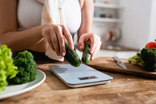 Cropped View Woman Putting Cucumbers Kitchen Scales — Stock Photo, Image