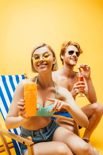 Blonde Woman Sitting Deck Chair Pointing Finger Orange Juice Young — Stock Photo, Image