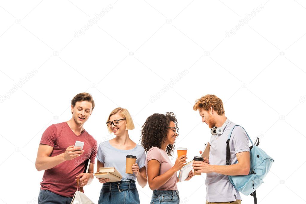 Multiethnic students holding coffee to go, books and smartphone isolated on white