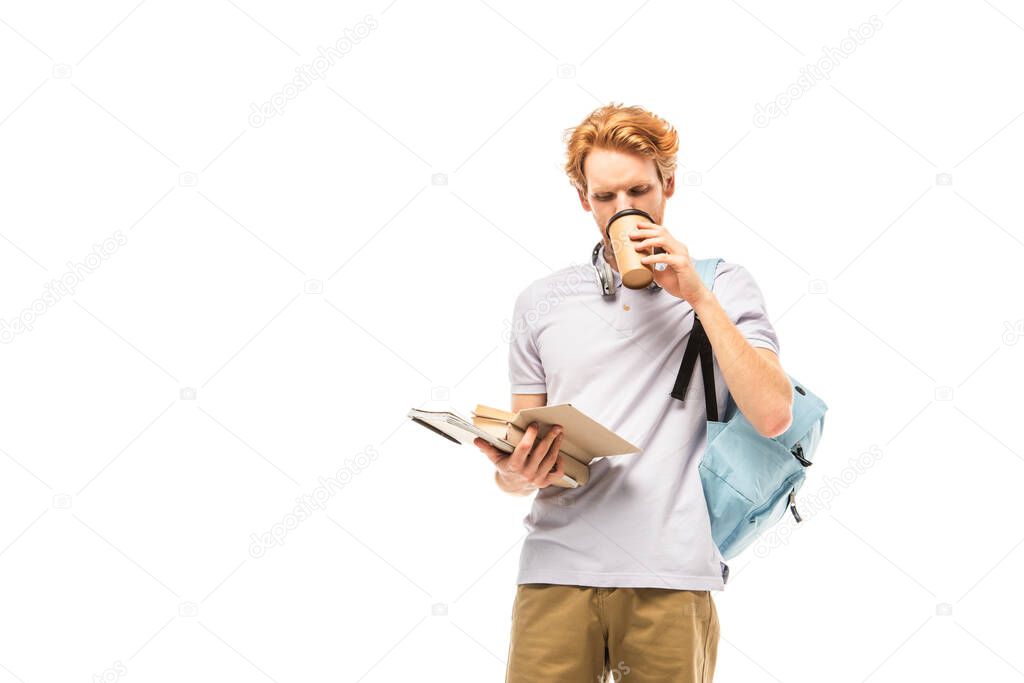 Student drinking coffee to go while reading book isolated on white