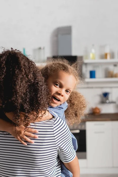 Back View Woman Striped Shirt Holding African American Daughter While — Stock Photo, Image