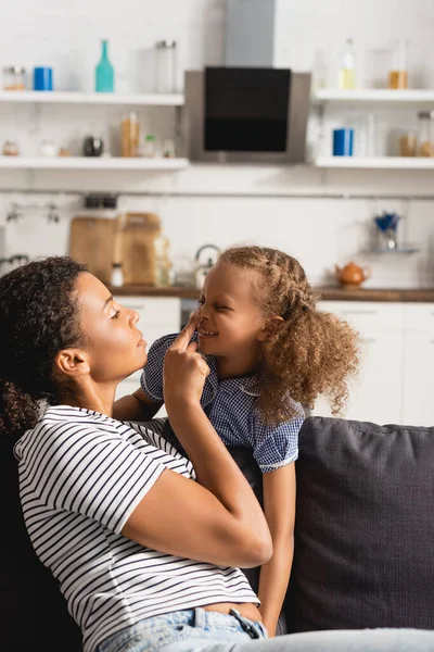 Young African American Mother Touching Nose Excited Daughter While Having — Stock Photo, Image