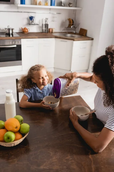 High Angle View African American Woman Pouring Cornflakes Bowl Daughter — Stock Photo, Image