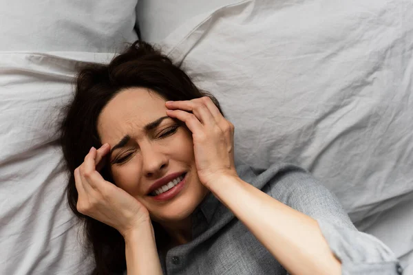 Top View Brunette Woman Suffering Pain Touching Head While Lying — Stock Photo, Image