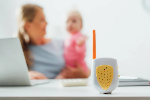 Selective Focus Baby Monitor Table Woman Holding Kid Background — Stock Photo, Image