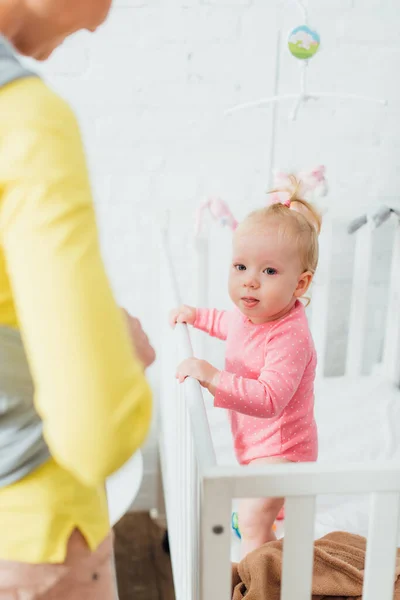 Selective Focus Woman Standing Baby Daughter Crib — Stock Photo, Image