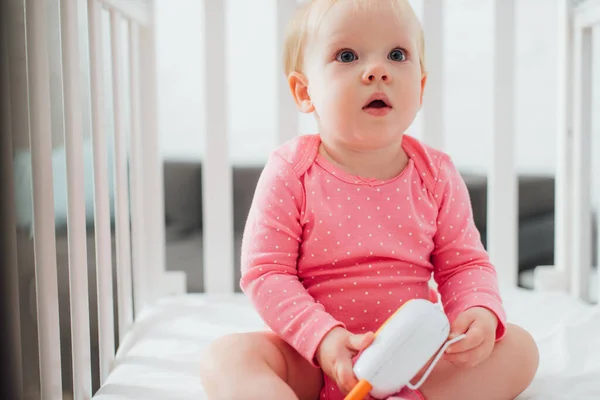 Selective Focus Excited Infant Holding Baby Monitor Crib — Stock Photo, Image