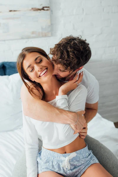 Man Kissing Neck Girlfriend Pajamas Bedroom — Stock Photo, Image