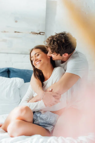 Selective Focus Young Man Embracing Girlfriend Closed Eyes Pajamas Bed — Stock Photo, Image