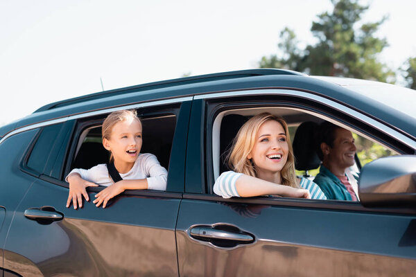 Selective focus of woman looking away during weekend on car with family 