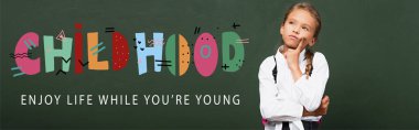 horizontal concept of thoughtful schoolgirl touching face near chalkboard with childhood, enjoy life while you are young lettering  clipart