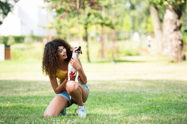 Selective focus of young woman holding jack russell terrier dog