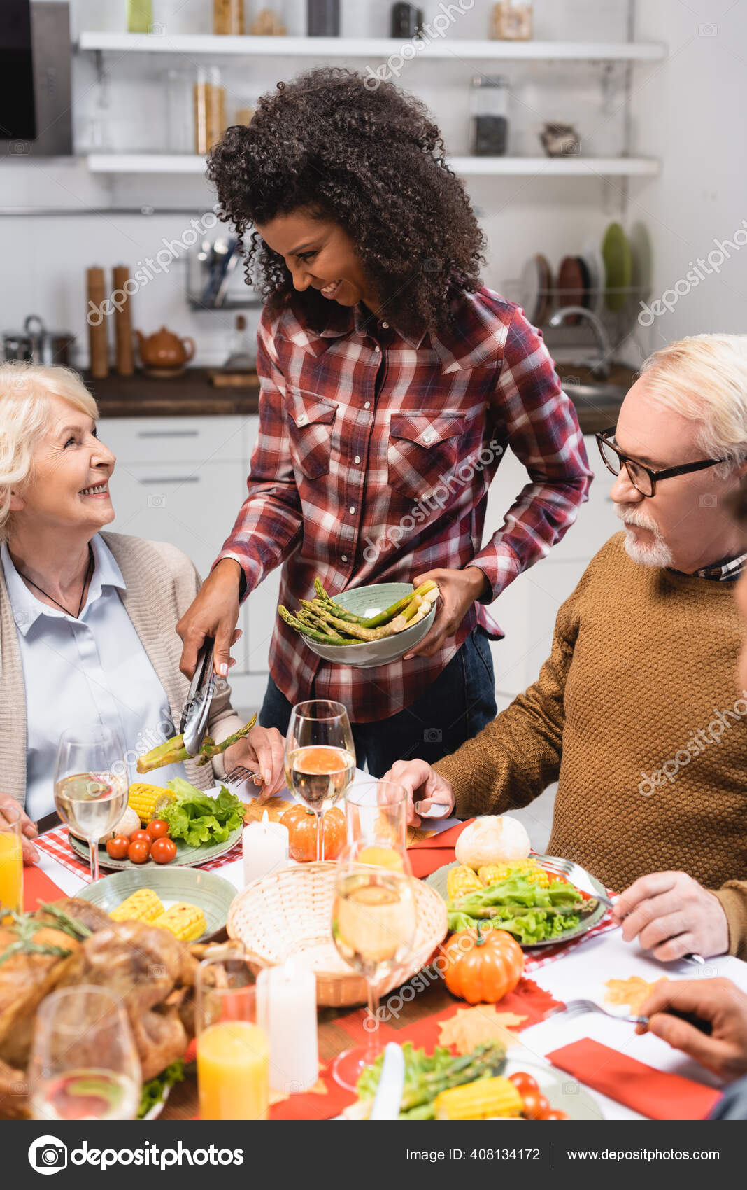 African American Woman Serving Asparagus Senior Woman Thanksgiving Dinner Stock Photo Image By C Haydmitriy 408134172