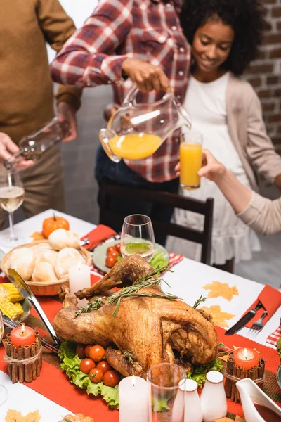 Cropped View Multicultural Family Pouring Beverages Table Served Delicious Thanksgiving — Stock Photo, Image