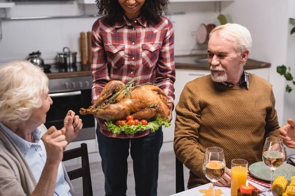 Selective Focus African American Woman Holding Turkey Multiethnic Family Kitchen — Stock Photo, Image