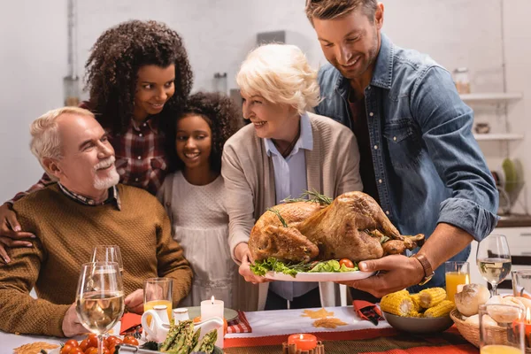 Selective Focus Elderly Woman Holding Tray Turkey Multicultural Family Thanksgiving — Stock Photo, Image