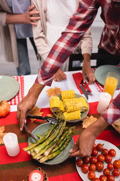 Cropped View African American Woman Putting Asparagus Table Thanksgiving Dinner — Stock Photo, Image