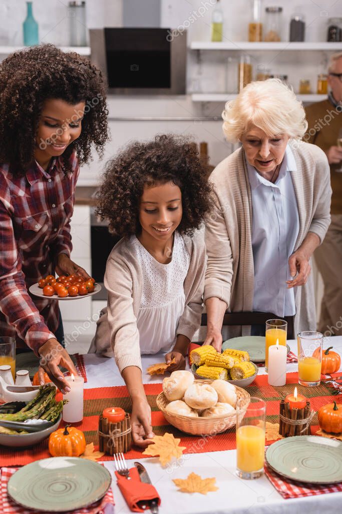 Selective Focus Of Multiethnic Women And African American Girl Serving Thanksgiving Dinner 408135528 Larastock