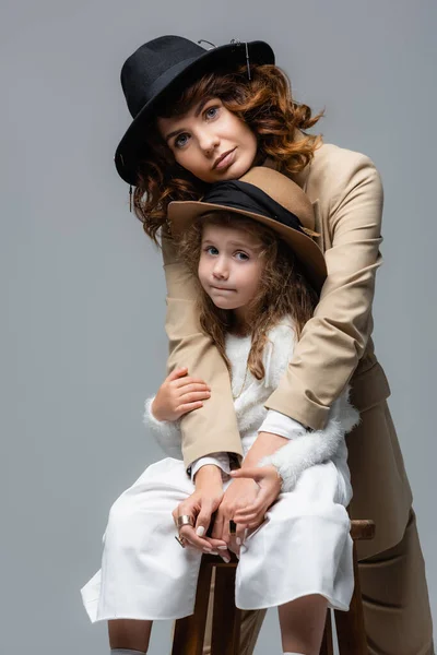 Elegant Mother Daughter White Beige Outfits Hugging Chair Isolated Grey — Stock Photo, Image