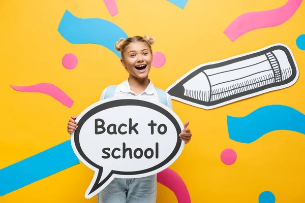 Excited Schoolchild Holding Speech Bubble Back School Lettering Multicolored Paper — Stock Photo, Image