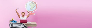 Panoramic shot of excited schoolgirl holding paper globe and magnifying glass near laptop and books on pink background clipart