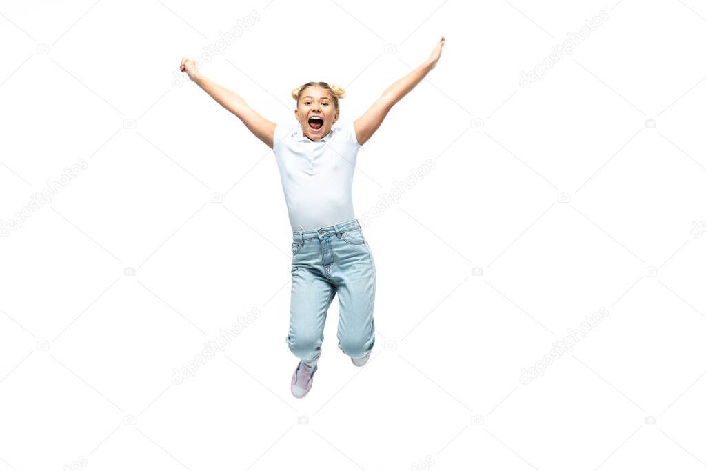 Excited schoolgirl jumping isolated on white 