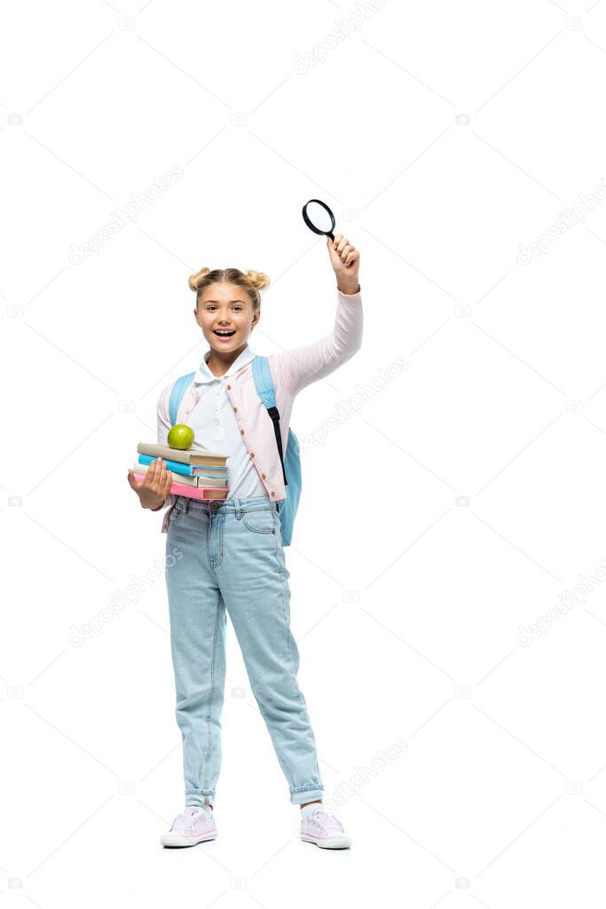 Girl with backpack holding loupe and books with apple on white background