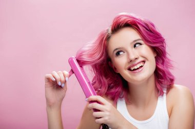 Pembe üzerine izole edilmiş düz saç kullanan renkli saçlı genç bir kadın.