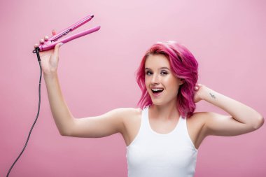 Renkli saçlı genç bir kadın. Pembe üzerine izole edilmiş düz tutacağı var.