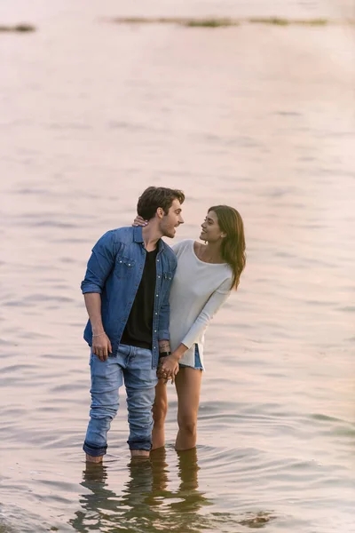 Morena Mujer Tocando Novio Mientras Pie Agua Mar Atardecer —  Fotos de Stock