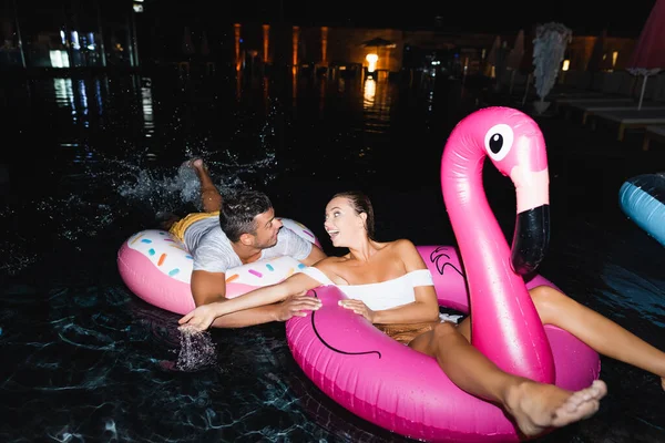 Selective Focus Excited Woman Looking Boyfriend While Sitting Swim Ring — Stock Photo, Image