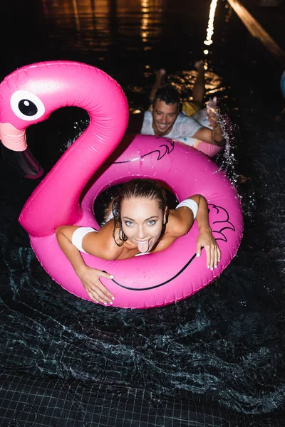 Overhead View Woman Sticking Out Tongue Boyfriend Swimming Pool Night — Stock Photo, Image