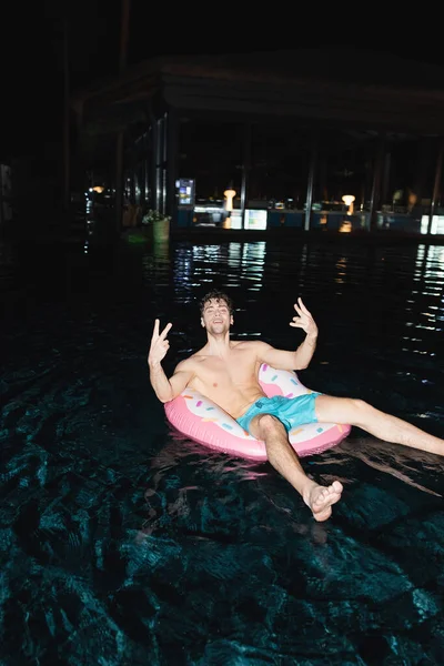 Selective Focus Shirtless Man Showing Peace Sign Swim Ring Pool — Stock Photo, Image