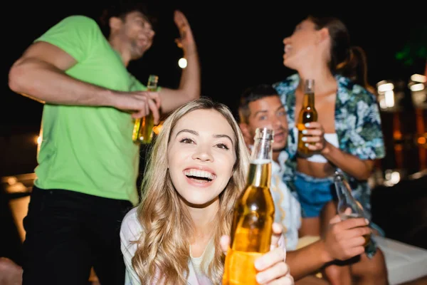 Selective Focus Woman Bottle Beer Looking Camera Boyfriend Friends Party — Stock Photo, Image