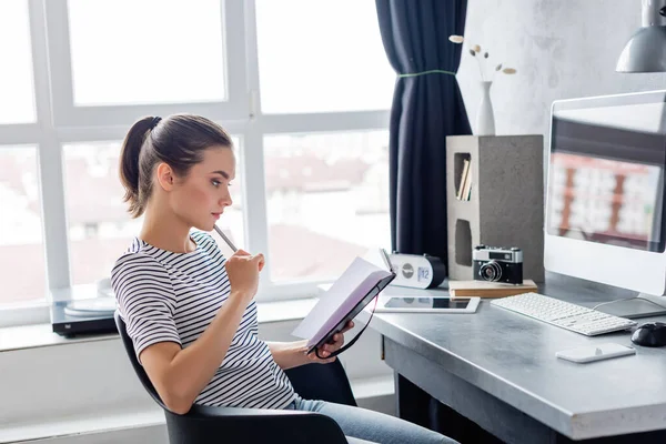 Young Freelancer Holding Pen Notebook While Working Home — Stock Photo, Image