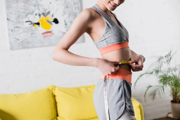 Cropped View Sportswoman Measuring Waist Tape Home — Stock Photo, Image