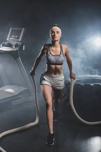 Young Sportswoman Training Battle Rope Treadmill Tire Gym Smoke — Stock Photo, Image