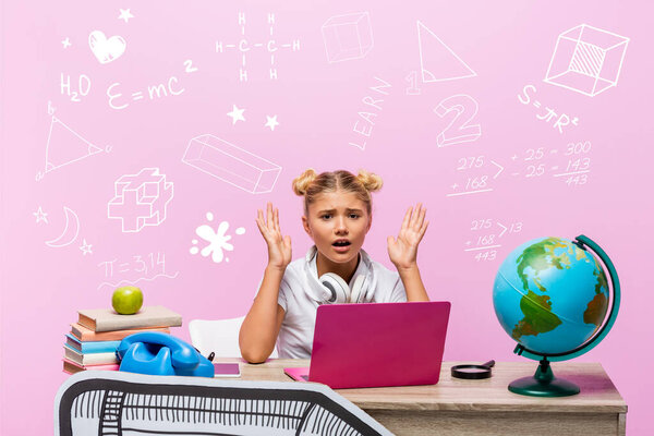 Worried kid looking at camera near laptop, books, paper art, globe, retro telephone and illustration on pink 