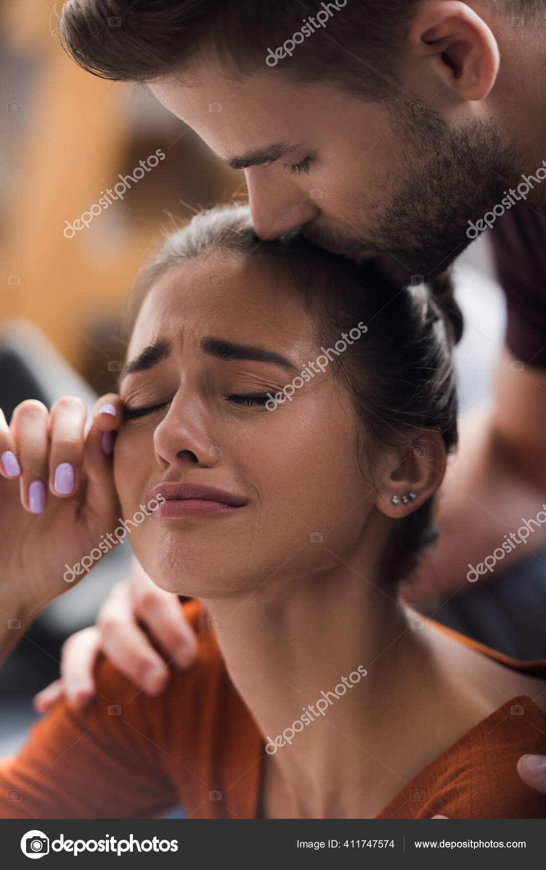 Girl Crying Next to a Kissing Couple