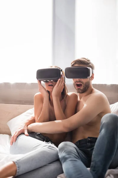 Young Woman Touching Headset Scared Boyfriend Bedroom — Stock Photo, Image