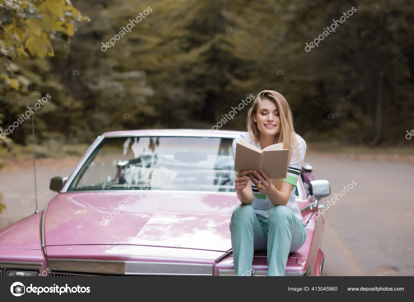 Happy Young Woman Reading Book While Sitting Hood Convertible Car Stock  Photo by ©HayDmitriy 413045960