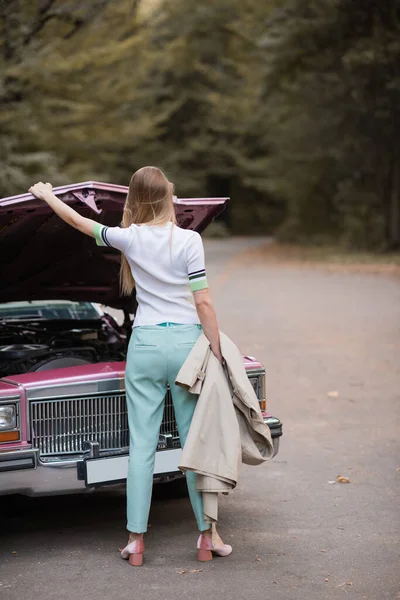 Back View Young Woman Holding Cape While Opening Hood Broken — Stock Photo, Image